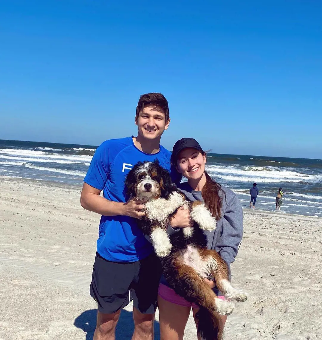 Grayson and Morgan carrying their dog on a trip to the beach in March 2021