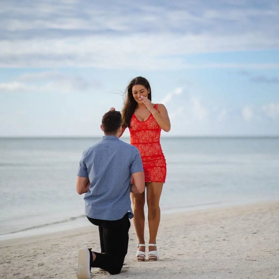 Grayson got down on one knee to propose to Morgan in front of an ocean