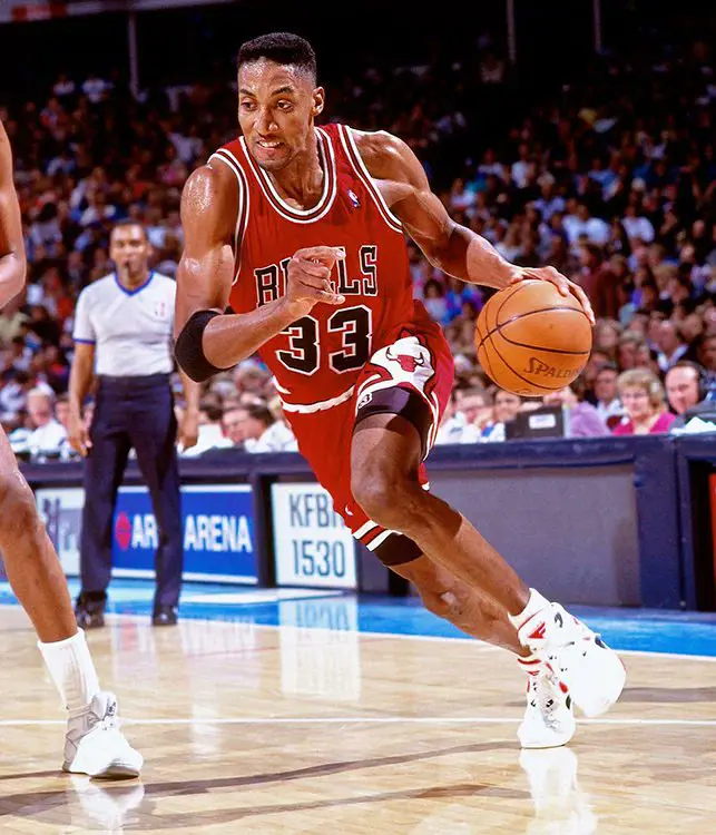 Pippen Donning A Bulls Jersey And Dribbling A Basketball During A Game