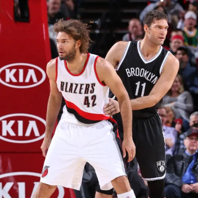 The Lopez brothers playing against each other during the Nets-Trail Blazers game